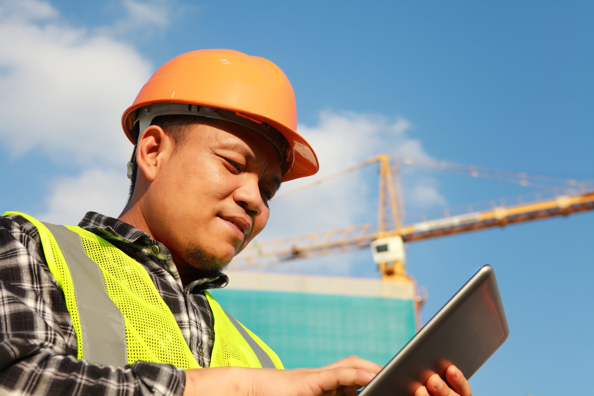construction worker looking at tablet